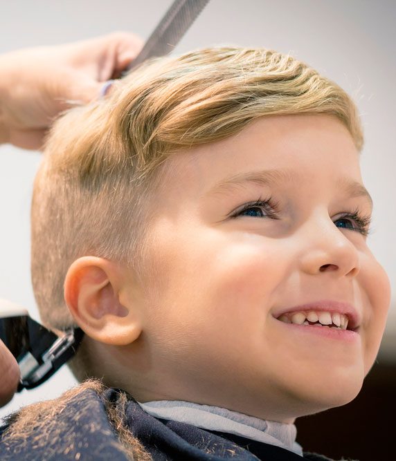 little boy getting a hair cut