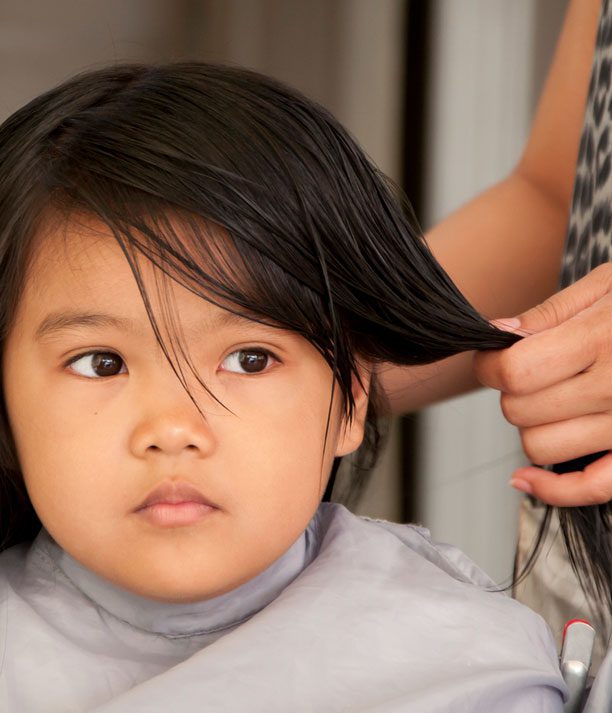 little girl getting a hair cut